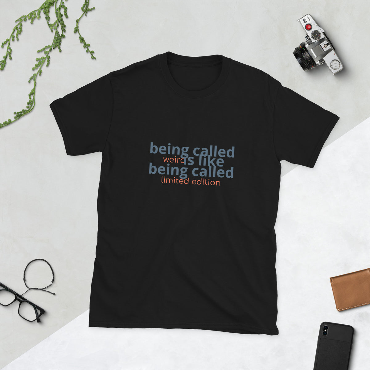 Black shirt displaying the quote 'being called weird is like being called limited edition weird quote shirt'.