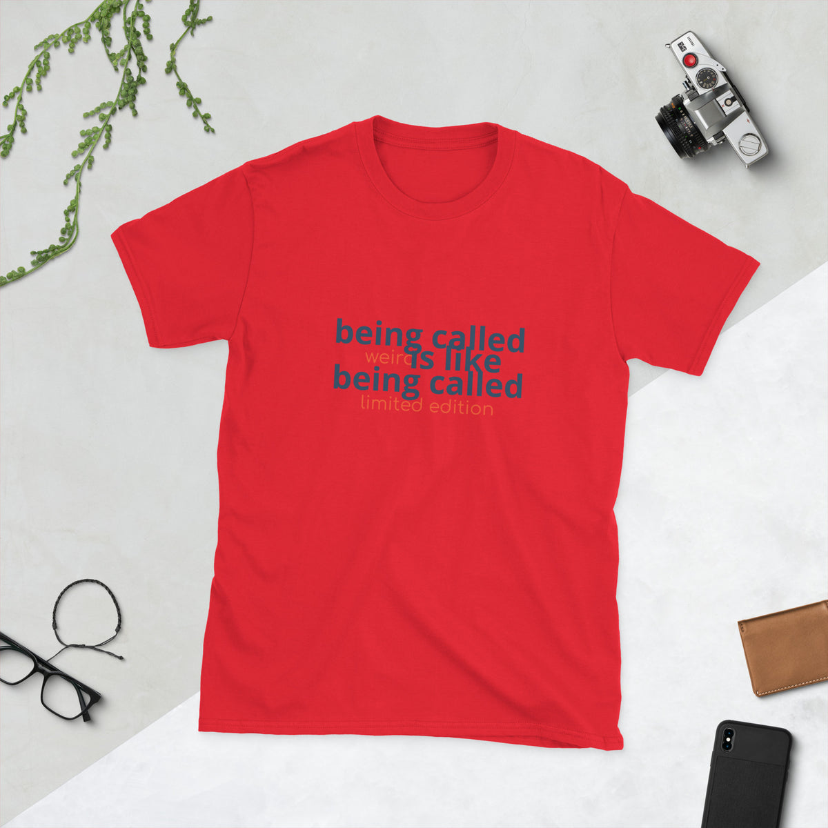 Black shirt displaying the quote 'being called weird is like being called limited edition weird quote shirt'.