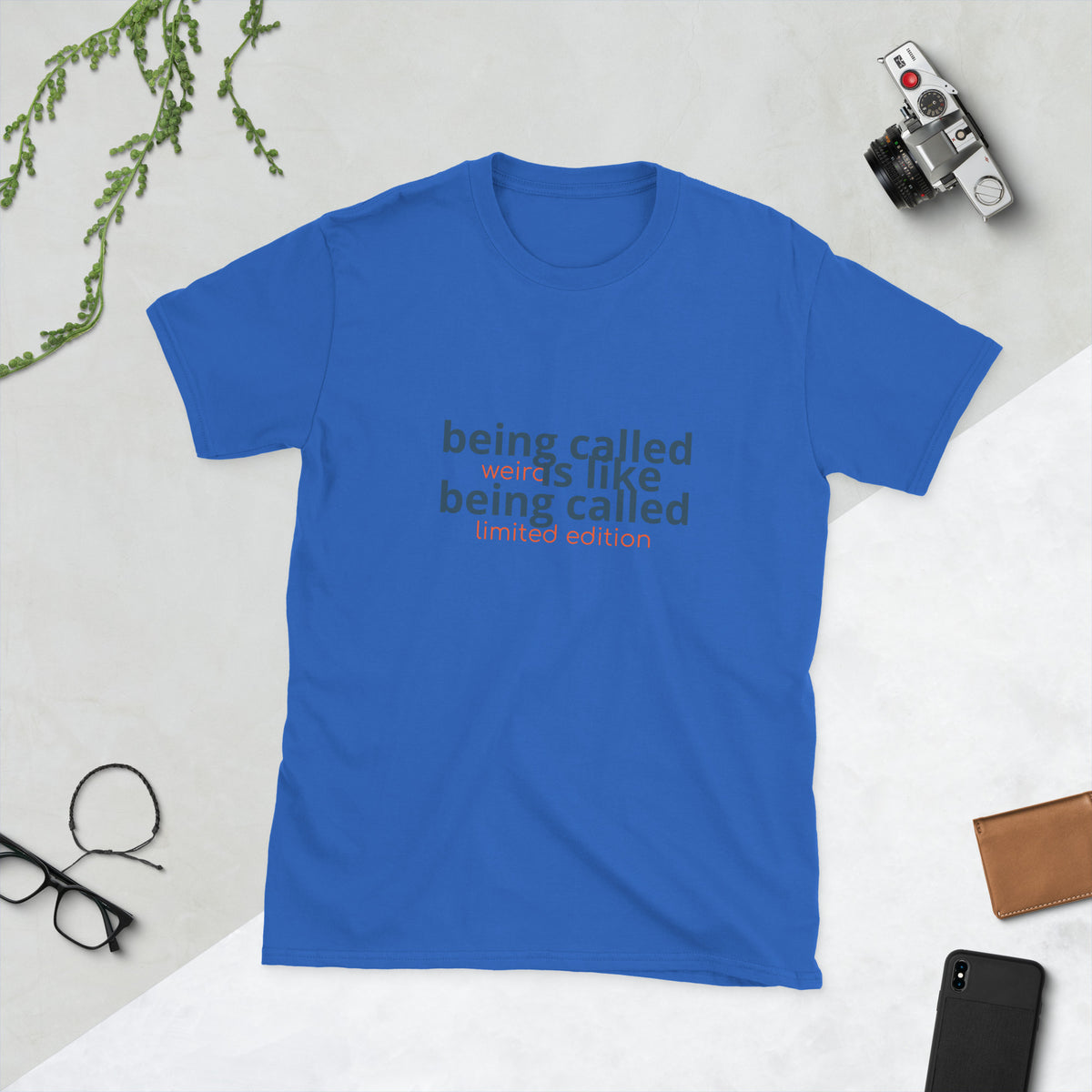 Black shirt displaying the quote 'being called weird is like being called limited edition weird quote shirt'.