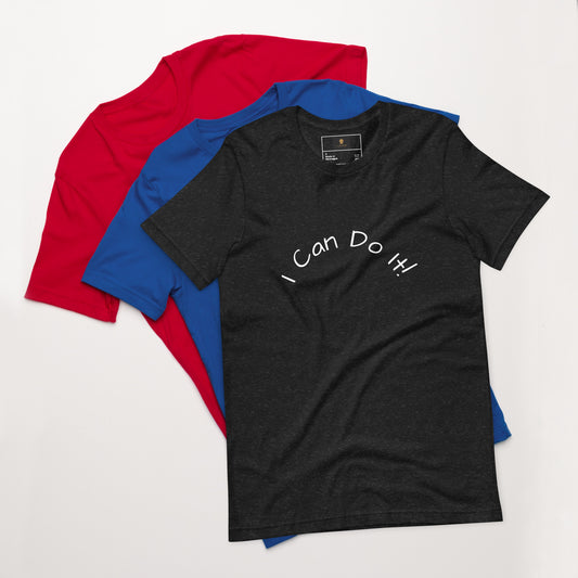 I Can Do It Unisex T-shirt in gray with red and blue shirts stacked in the background.