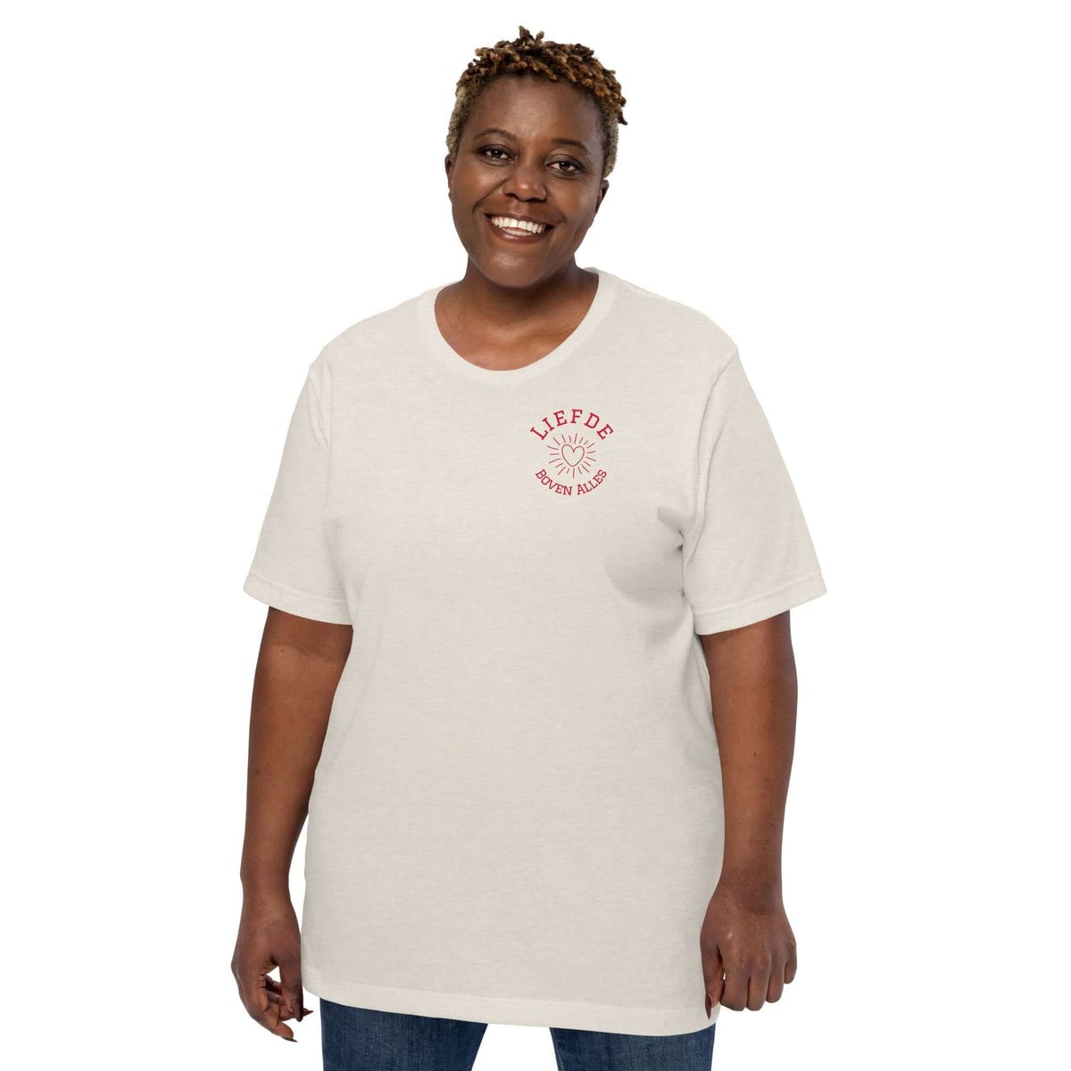 Liefde Boven Alles T-shirt displayed on a smiling model wearing casual attire in light color.