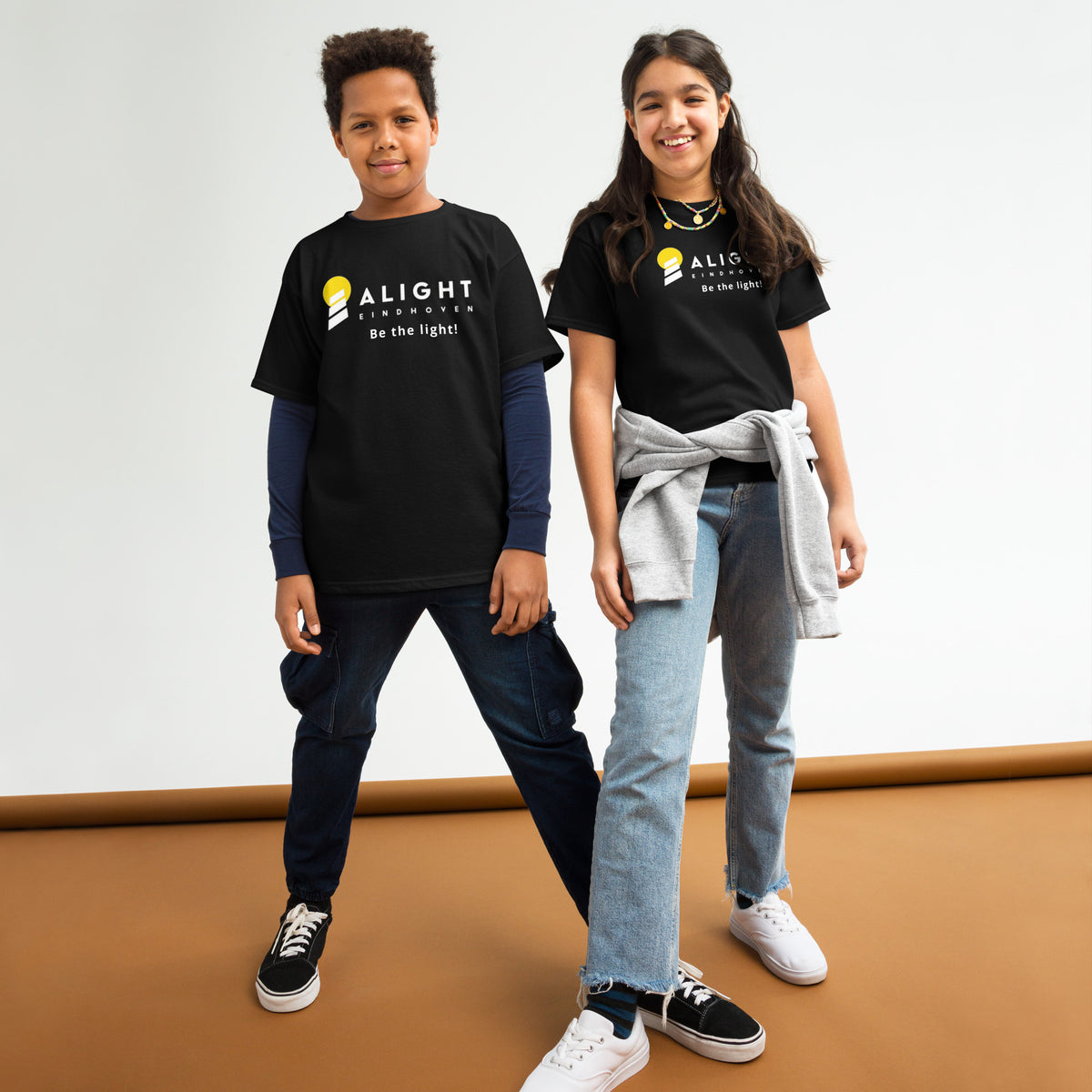 Alight Youth T-shirt worn by kids, showcasing a playful, stylish design that promotes joy and positivity.