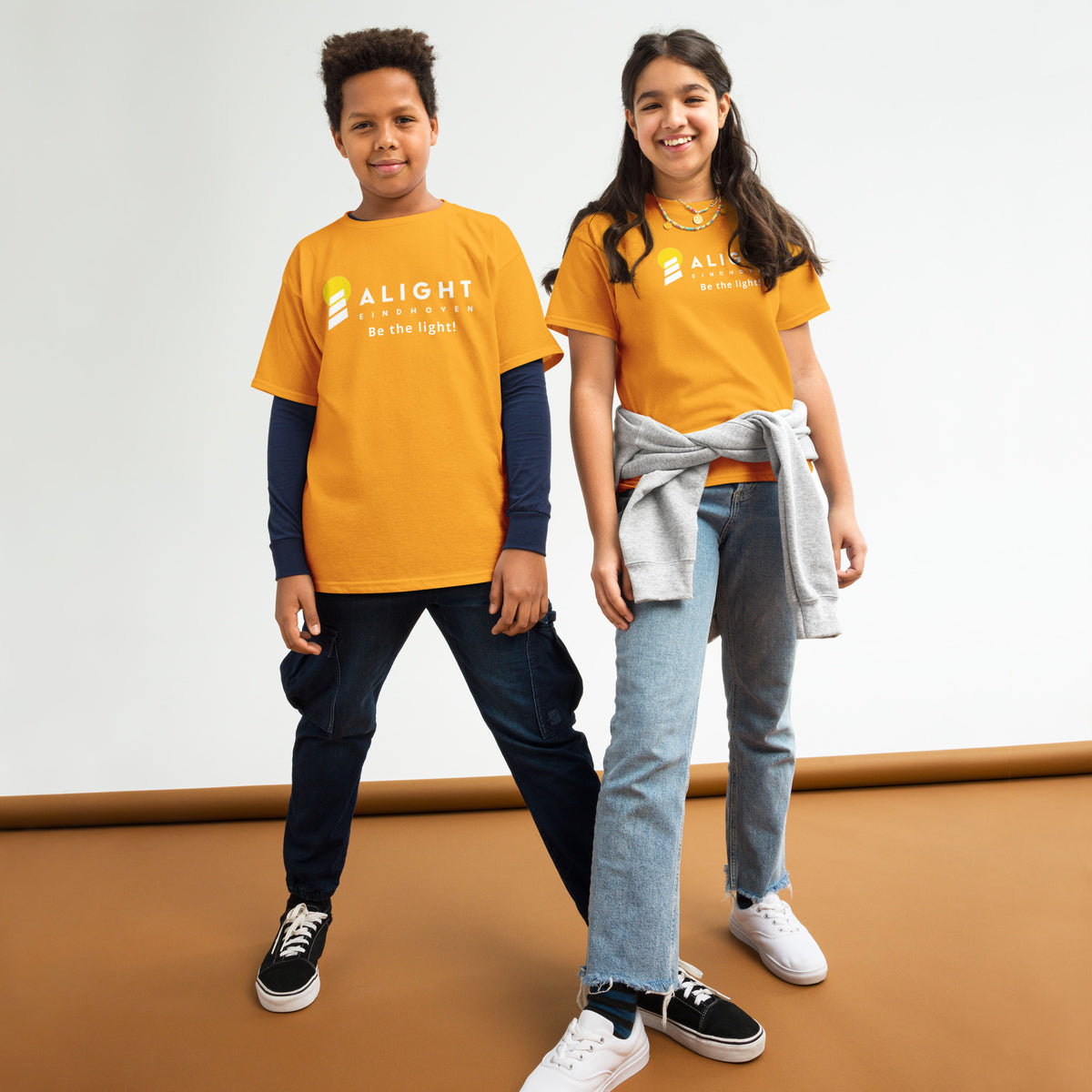 Alight Youth T-shirt worn by kids, showcasing a playful, stylish design that promotes joy and positivity.