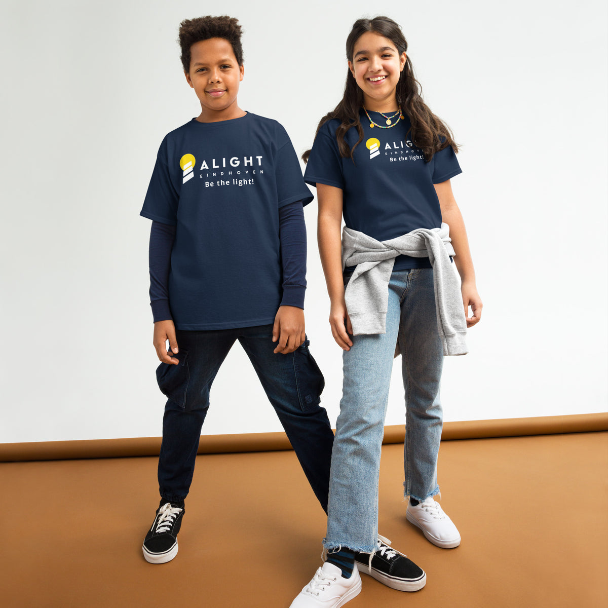 Alight Youth T-shirt worn by kids, showcasing a playful, stylish design that promotes joy and positivity.