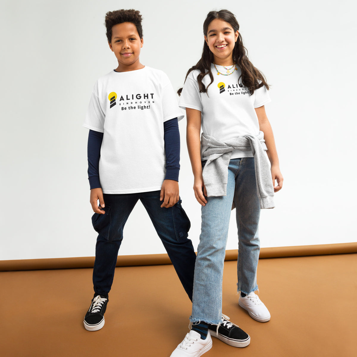 Alight Youth T-shirt worn by kids, showcasing a playful, stylish design that promotes joy and positivity.